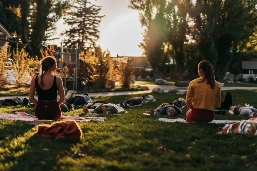 A group of women enjoy a yoga retreat in nature.